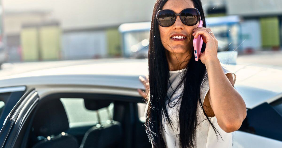 Woman on phone by car